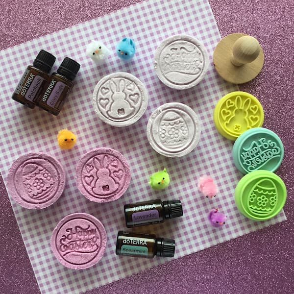 easter bath bombs surrounded by doterra essential oils and cookie stamps