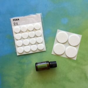 ikea stick-on floor protectors and a bottle of doterra terrashield essential oil