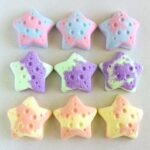 starfish bath bombs in pink and blue, green and purple, orange and yellow, three of each