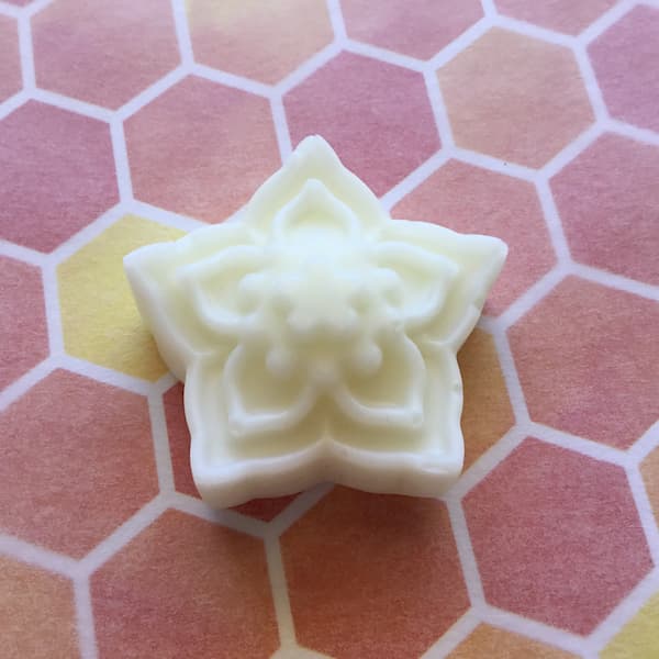 essential oil lotion bar in the shape of a  jasmine flower
