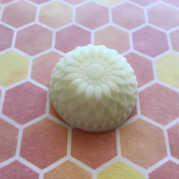 essential oil lotion bar in the shape of a dahlia flower