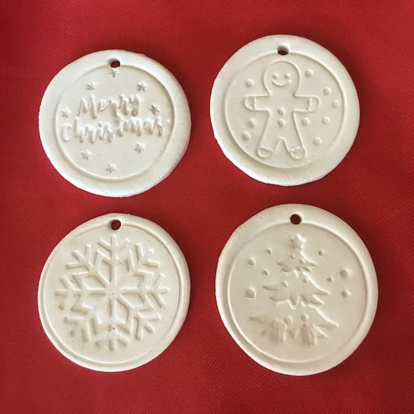 round essential oil diffuser ornaments made from clay embossed with christmas cookie stamps 