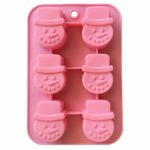 pink silicone mould with six cavities in the shape of a snowman's face wearing a top hat