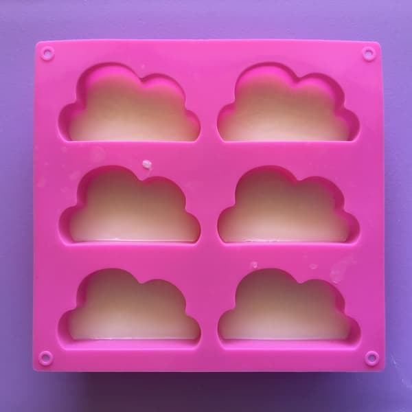 six cavity cloud shaped mold filled with melt and pour soap