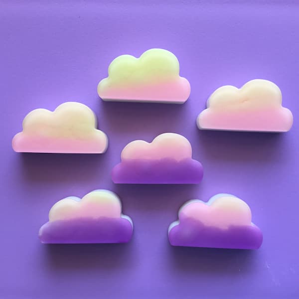 purple, pink, yellow and orange colored cloud shaped soap on a purple background