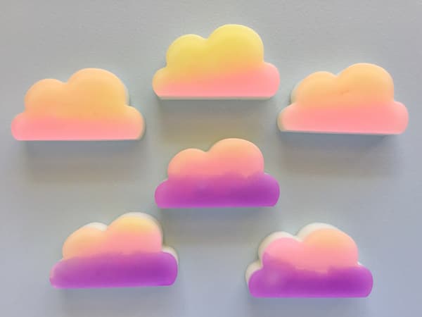 sunset colored soap bars on grey background